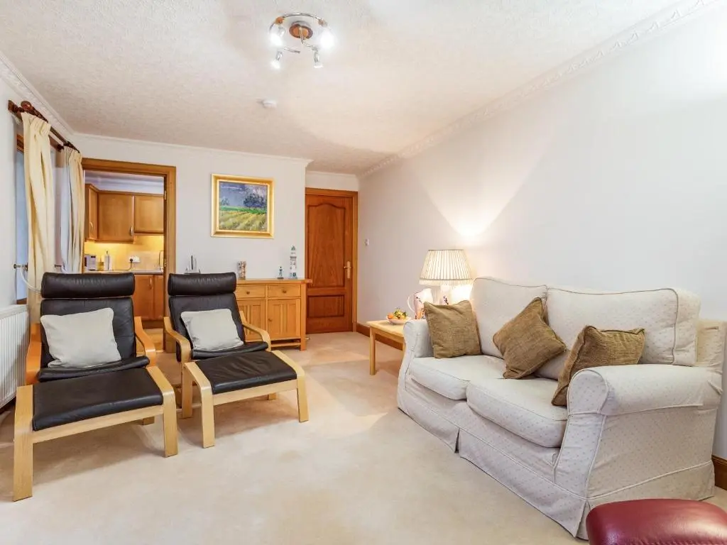 a living room with a couch and two chairs at Moray Firth View in Nairn