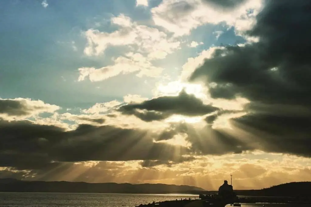 a cloudy sky with the sun shining through the clouds at Seacot Cottage in the heart of the Highlands in South Kessock
