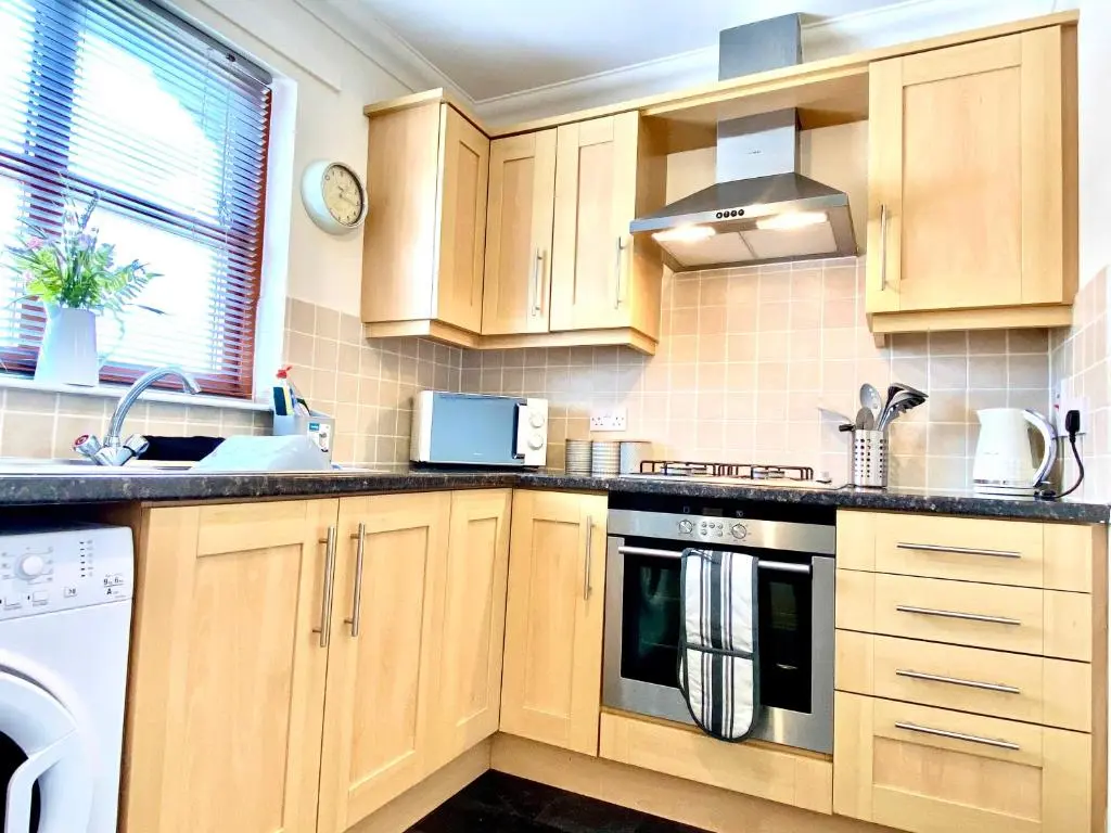 a kitchen with wooden cabinets and a stove top oven at 100 Thornhill Drive, Elgin in Elgin