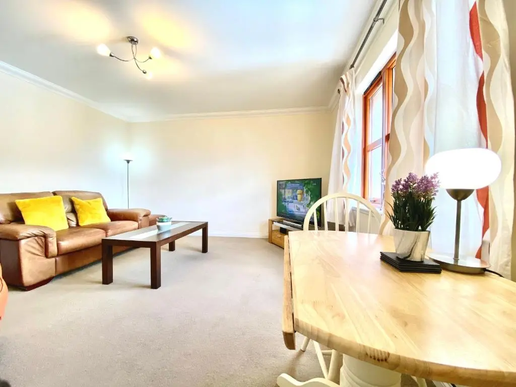 a living room with a couch and a table at 100 Thornhill Drive, Elgin in Elgin