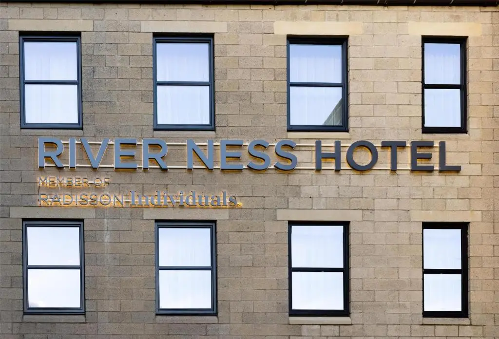 a hotel sign on the side of a building at River Ness Hotel, a member of Radisson Individuals in Inverness