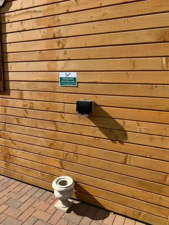 a wooden wall with a toilet in front of it at Immaculate Cabin 5 mins to Inverness Dog friendly in Inverness