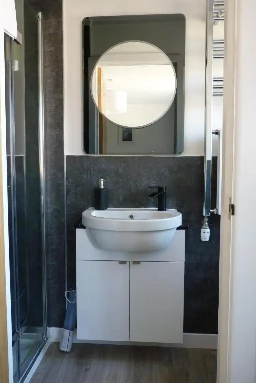 a bathroom with a white sink and a mirror at Tanleys B&B in Grantown on Spey