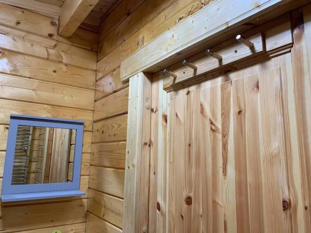 a log cabin with a mirror and a window at Immaculate cabin 5 mins to Inverness dogs welcome in Inverness