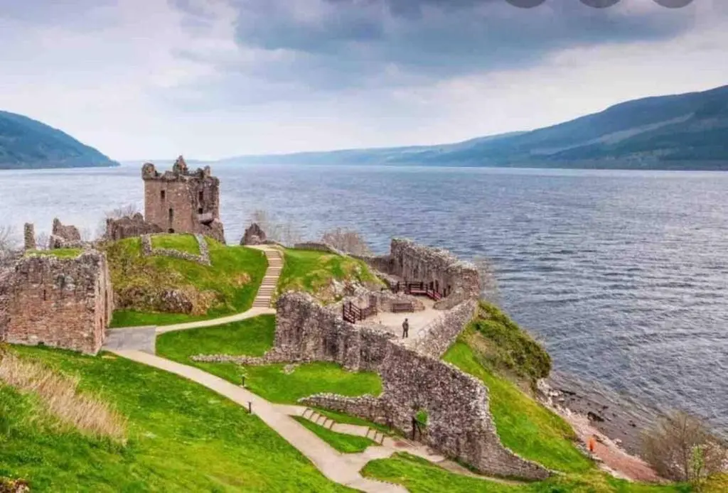 a castle on the shore of a body of water at Immaculate cabin 5 mins to Inverness dogs welcome in Inverness
