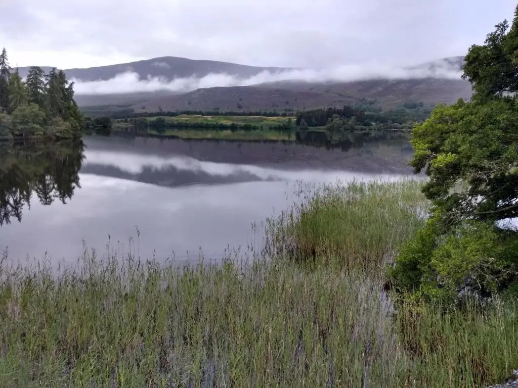a view of a lake with mountains in the background at Ardvonie House in Kingussie
