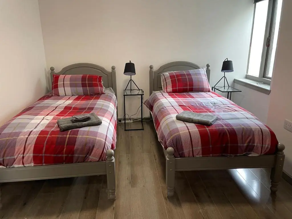 two beds sitting next to each other in a bedroom at Rooms in Inverness in Inverness