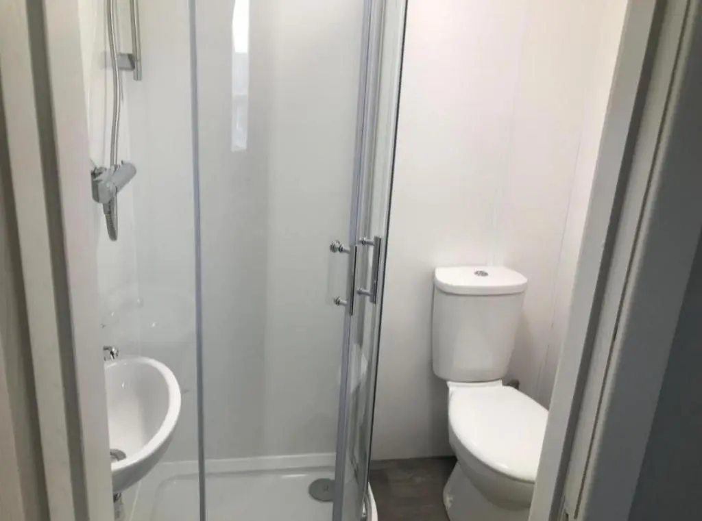 a bathroom with a shower and a toilet and a sink at Harbour bridge, Camps bar in Wick