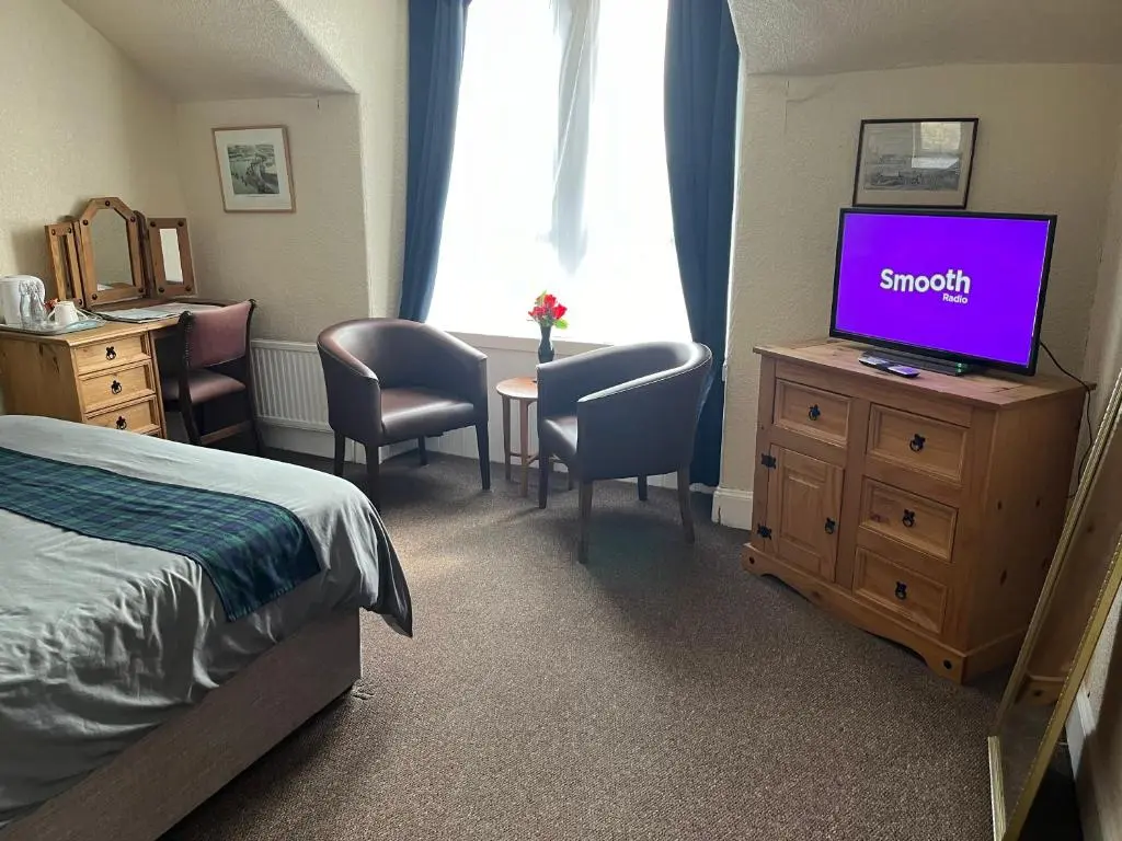 a bedroom with a bed and a flat screen tv at Harbour bridge, Camps bar in Wick