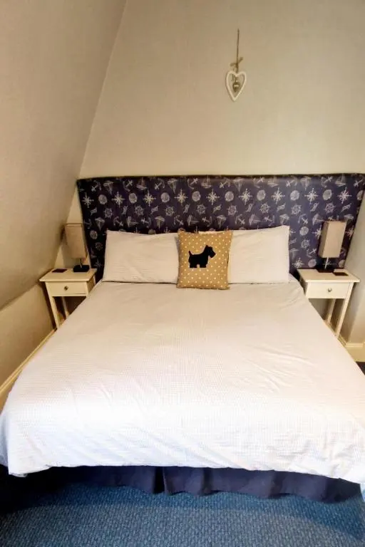 a bedroom with a large white bed with a headboard at Harbour bridge, Camps bar in Wick