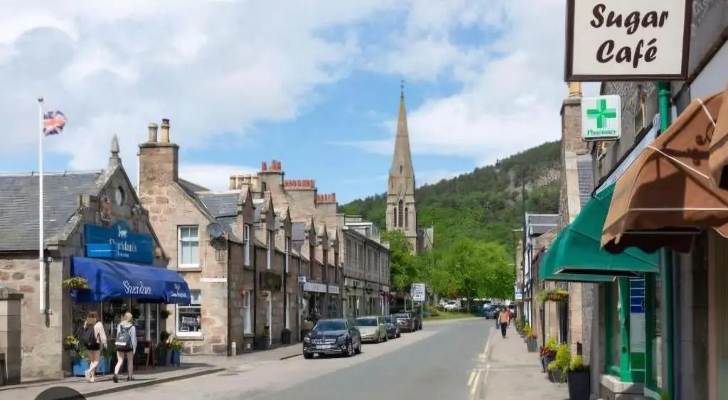 a street in a small town with a church at Pannanich View Cottage, Ballater in Ballater