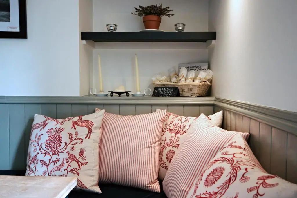 a group of pillows sitting on a couch in a room at The Boat Inn in Aboyne