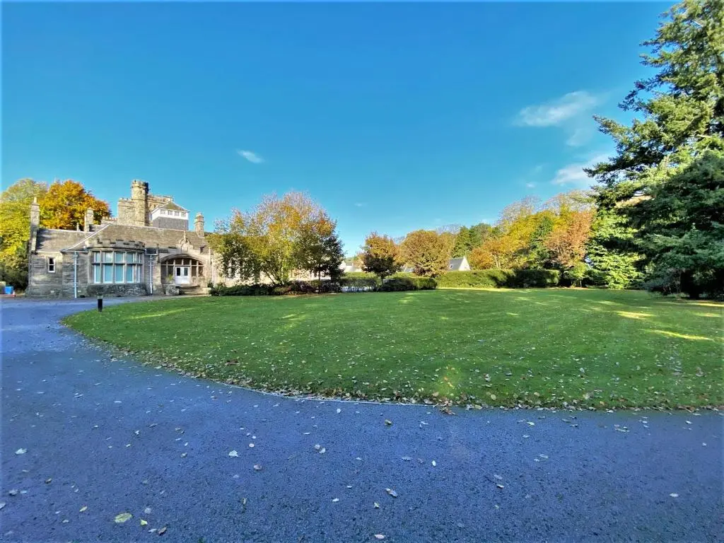 a large house with a large grassy yard at Grampian Serviced Apartments - Treetops Apartments in Elgin