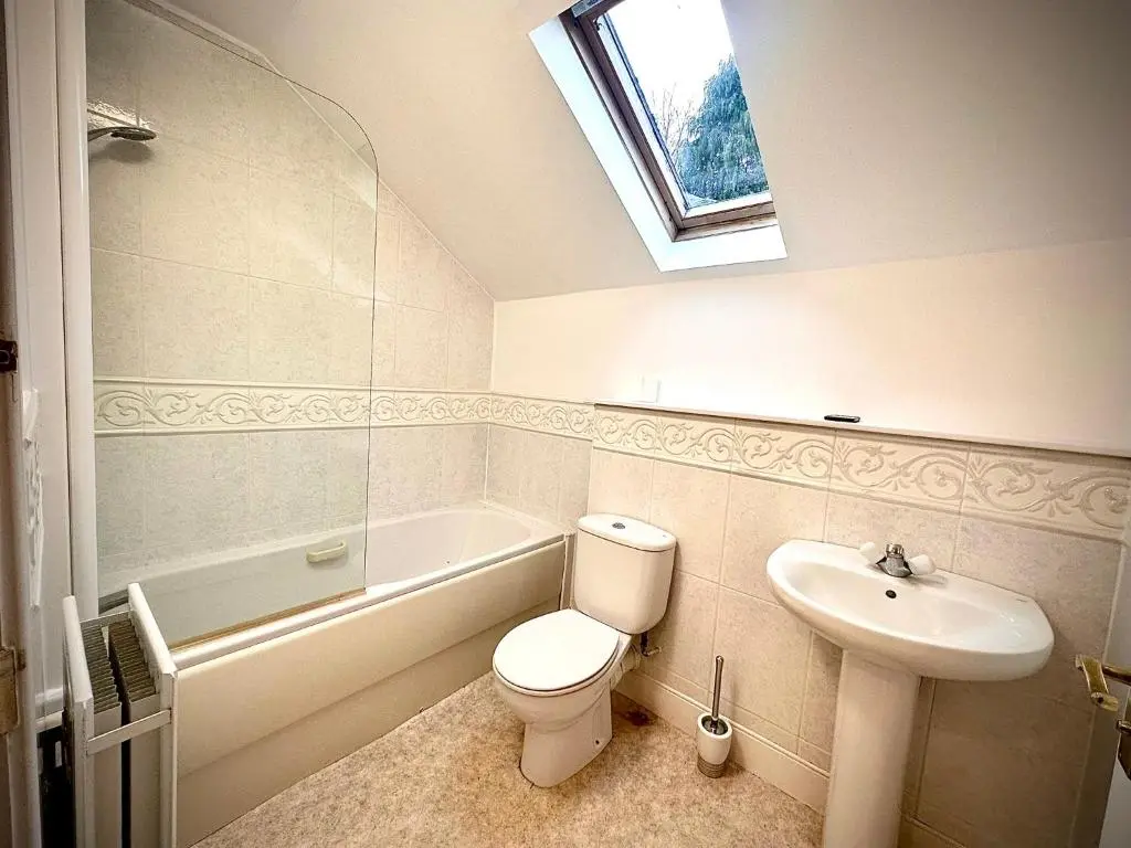 a bathroom with a white toilet and a sink at Grampian Serviced Apartments - Treetops Apartments in Elgin
