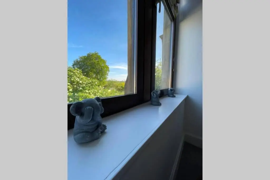 a window sill with a teddy bear figurines on it at No 10 Immaculate City Centre, Top Floor 2 Bed Flat with Free Parking in Inverness