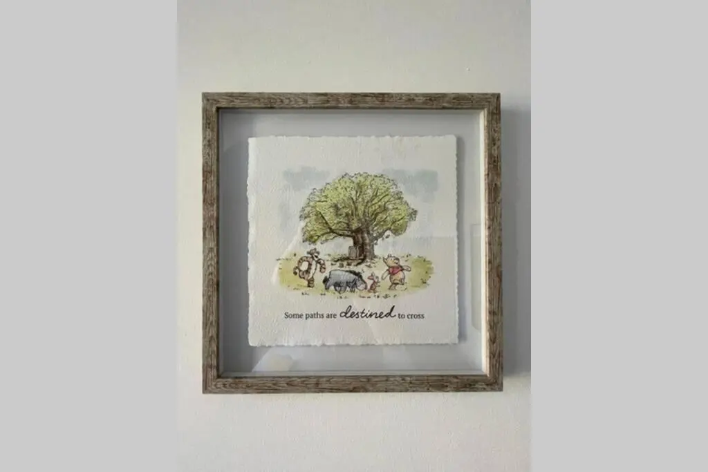 a picture of a framed picture of animals under a tree at No 10 Immaculate City Centre, Top Floor 2 Bed Flat with Free Parking in Inverness
