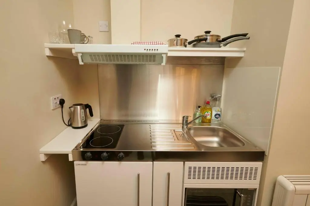 a small kitchen with a sink and a stove at Downright Gabbler in Beauly