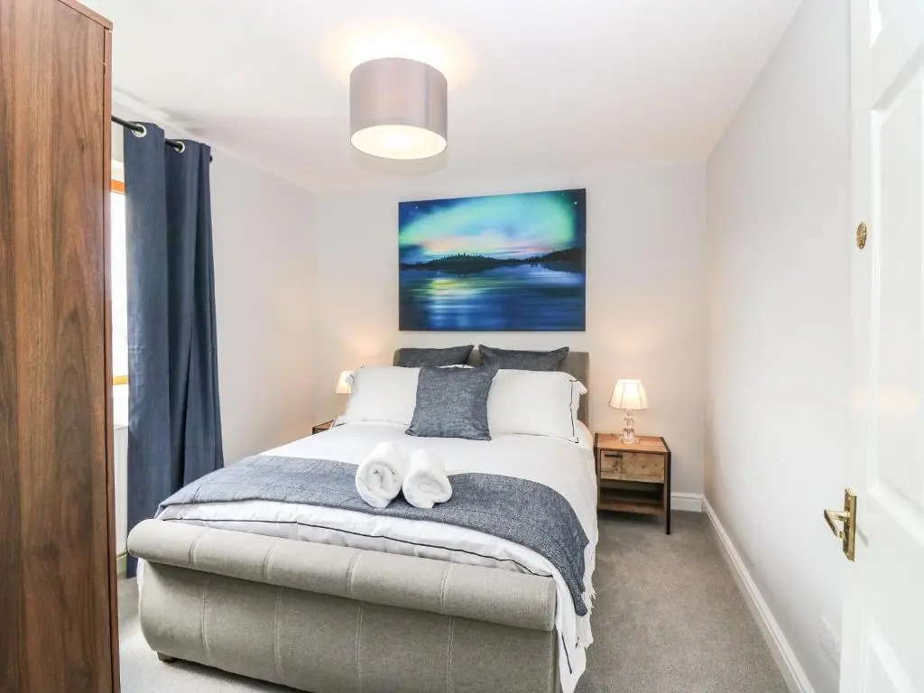 a bedroom with a bed with two towels on it at Tombeck in Tomintoul
