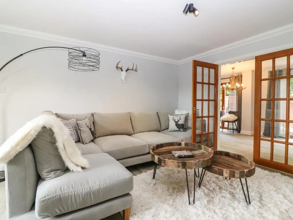 a living room with a couch and a table at Tombeck in Tomintoul