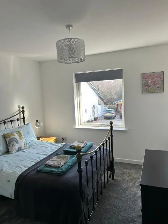 a bedroom with a bed and a window at Woodside retreat holiday home in Aviemore in Aviemore