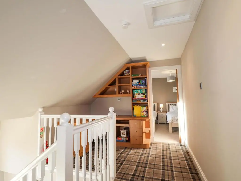 a white staircase in a home with a room at 3 Croftside in Aviemore