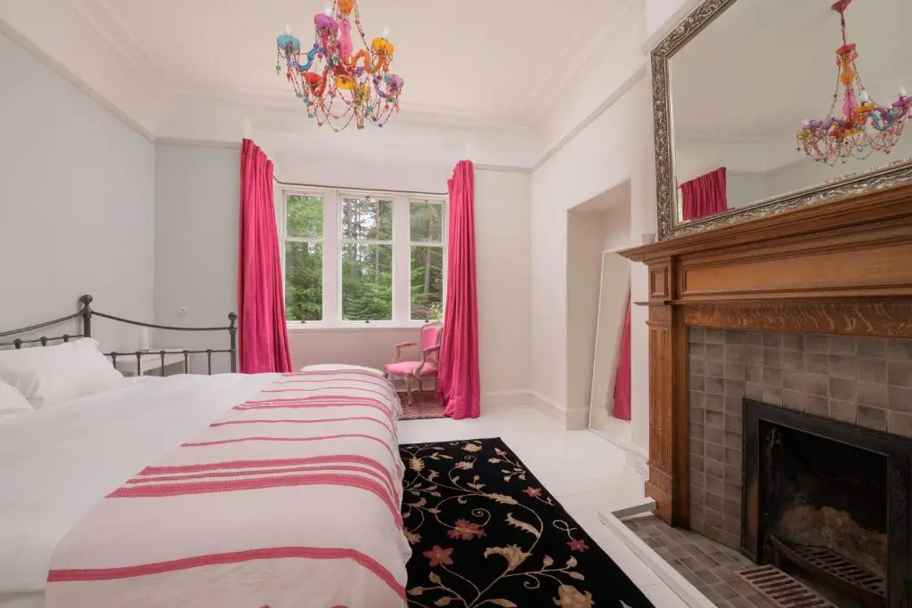 a bedroom with a bed and a fireplace at Haven Retreat Scotland - Large 4 Bed House with Woodland garden, Aboyne ,Royal Deeside in Aboyne