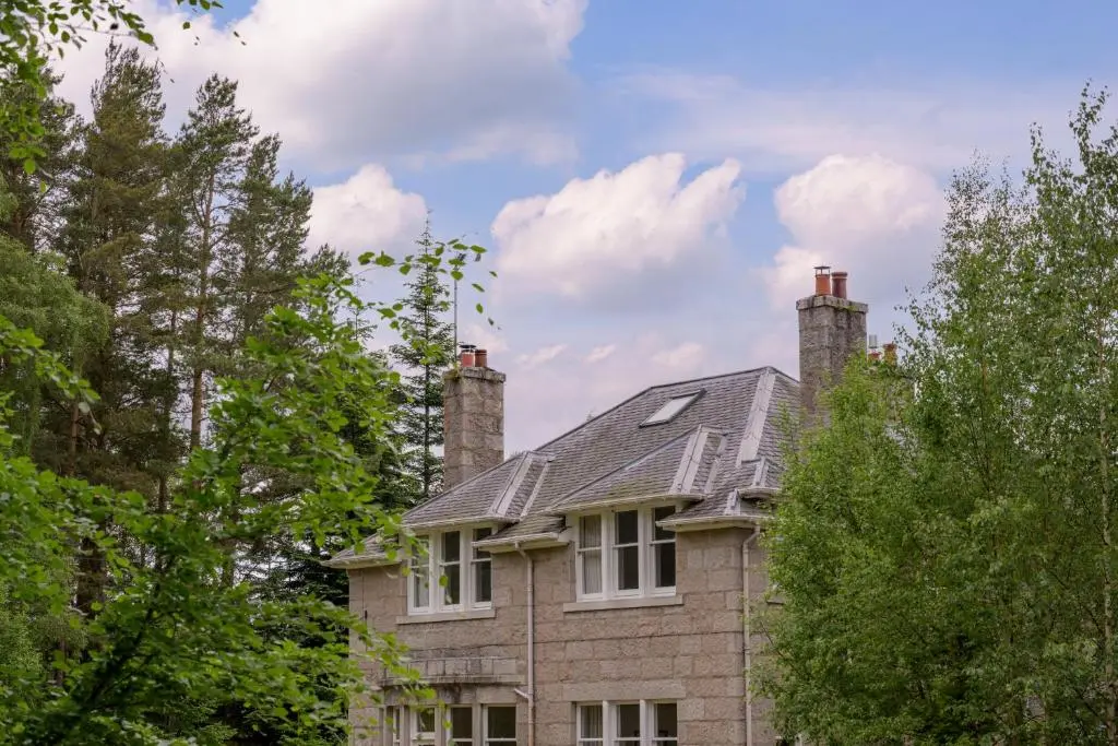 a brick house with two chimneys on top of it at Haven Retreat Scotland - Large 4 Bed House with Woodland garden, Aboyne ,Royal Deeside in Aboyne