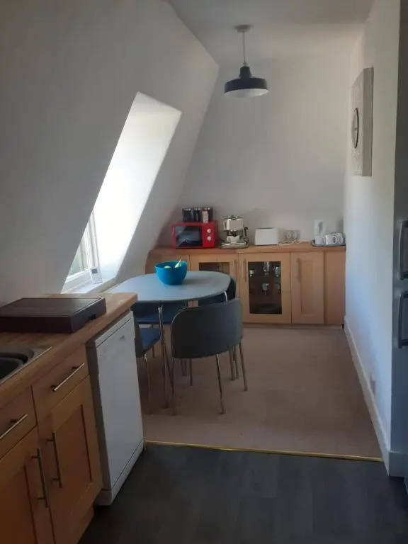 a kitchen with a table and a small table with chairs at Just off the Square... Ballater in Ballater