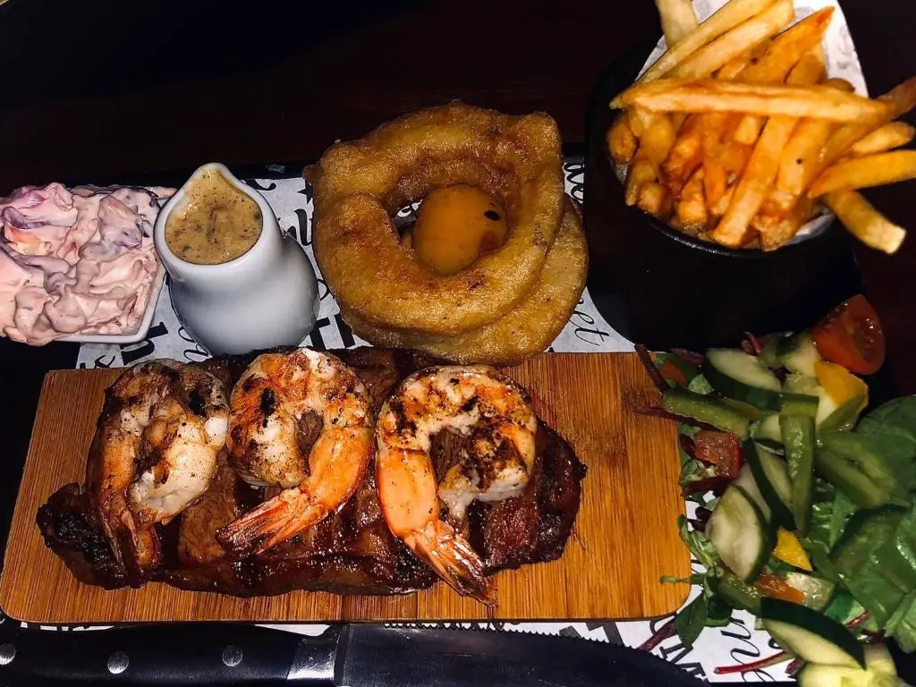 a plate of shrimp and onion rings and french fries at Bennachie Lodge Hotel in Kemnay in Inverurie