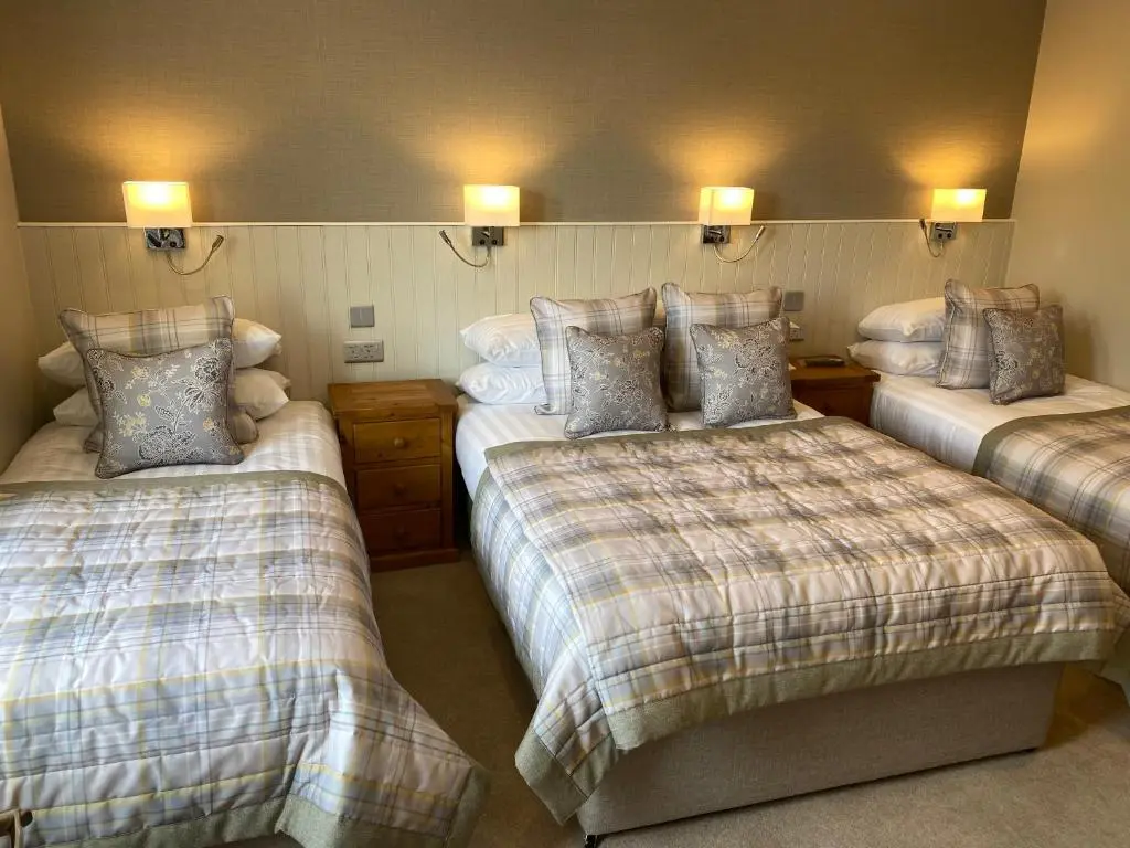 a bedroom with two beds with pillows on them at Adrian's Guest House in Inverness
