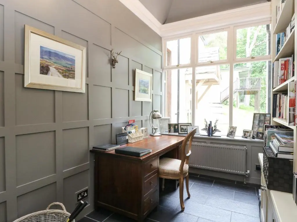 a home office with a desk and a window at Bearnock Lodge in Inverness