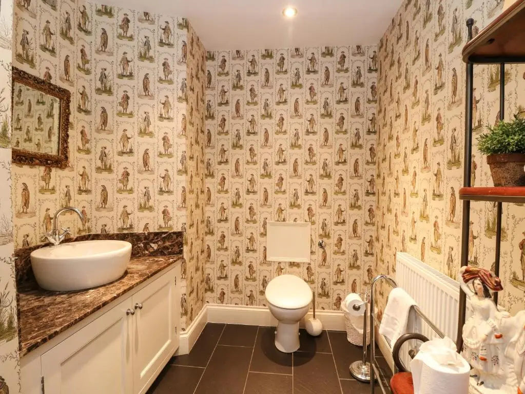 a bathroom with a sink and a toilet at Bearnock Lodge in Inverness