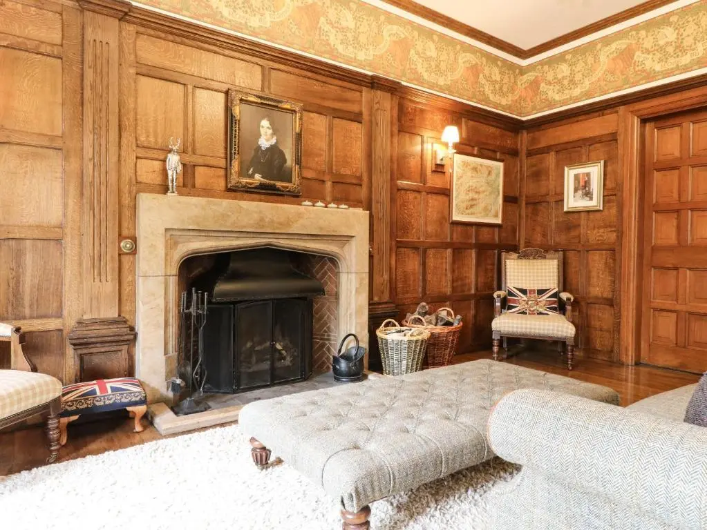 a living room with a fireplace and a couch at Bearnock Lodge in Inverness
