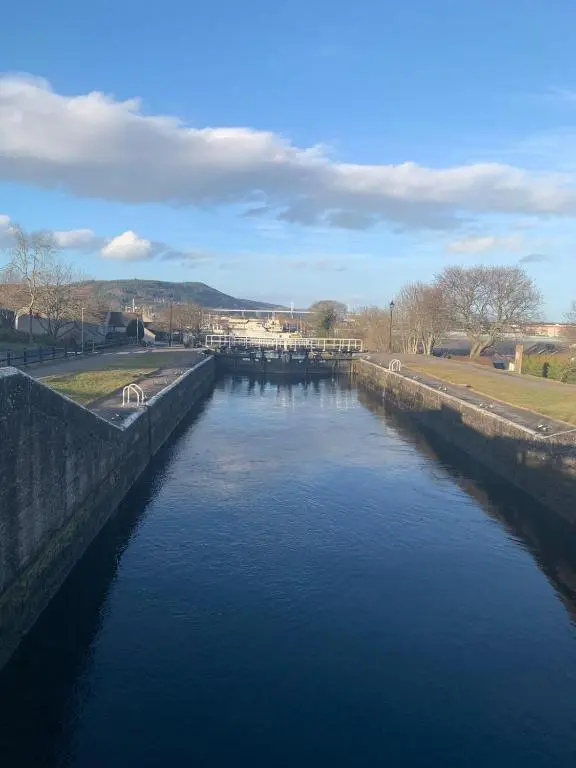 arial view of a canal of water with a bridge at Glencoe House Inverness in Inverness