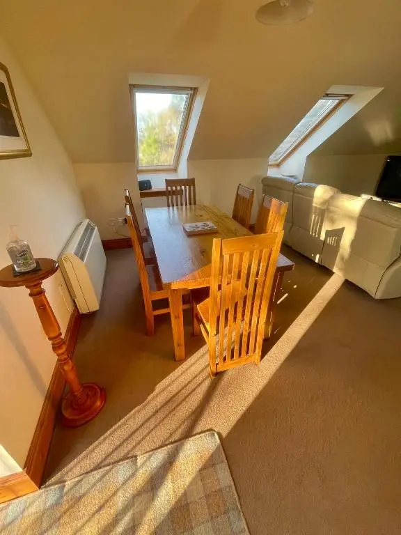 a room with a table and chairs and a bed at Macallen in Nairn