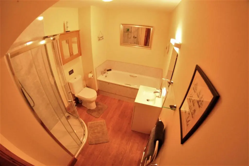 a bathroom with a tub and a toilet and a sink at Macallen in Nairn