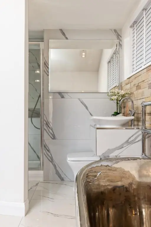 a bathroom with a sink and a mirror at Relax in Super Size Copper Tub - 2 bedroom villa in Inverness
