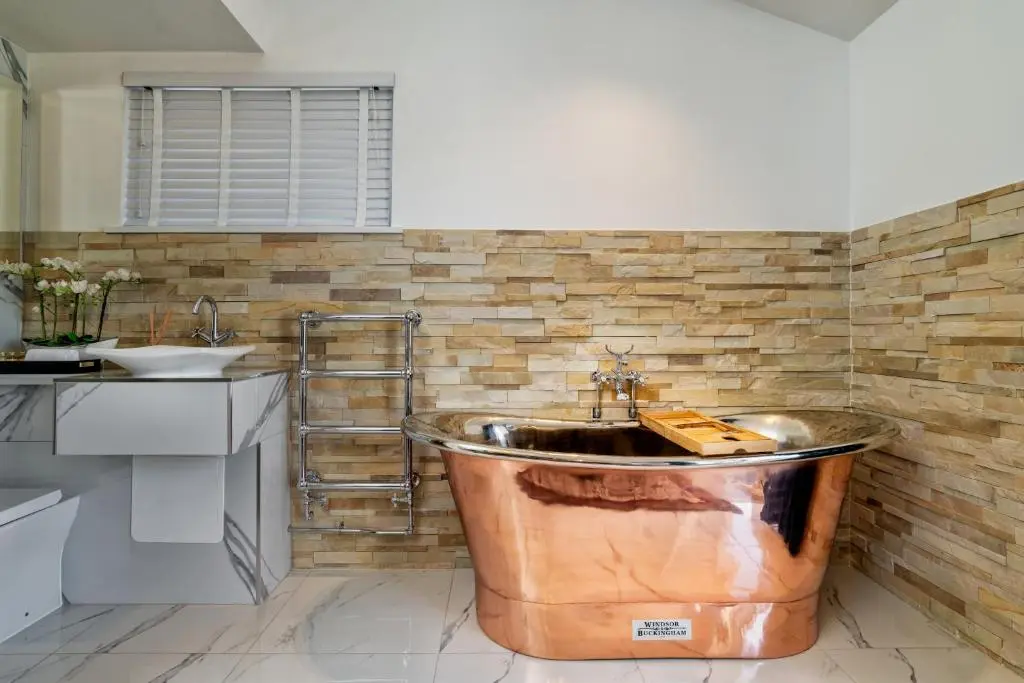 a large copper tub in a kitchen with a sink at Relax in Super Size Copper Tub - 2 bedroom villa in Inverness