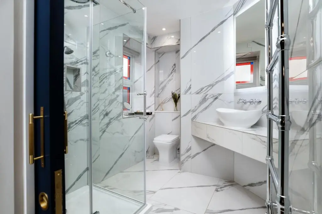 a bathroom with a glass shower and a toilet at Relax in Super Size Copper Tub - 2 bedroom villa in Inverness
