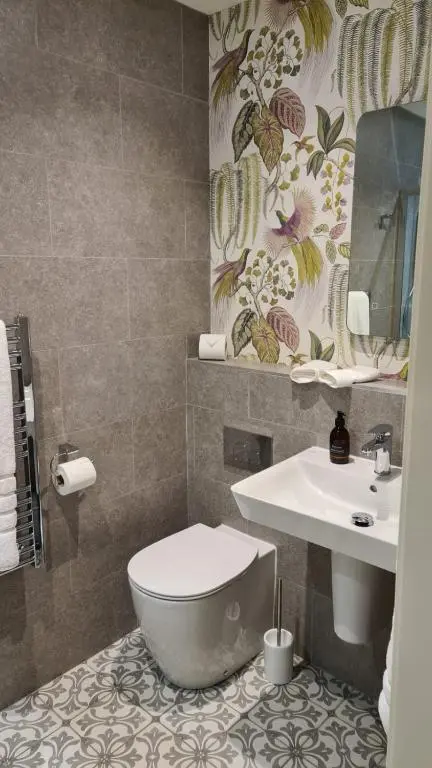 a bathroom with a toilet and a sink at Art House Apartments in Inverness
