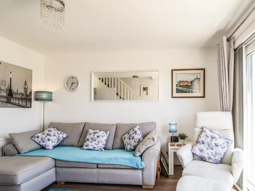a living room with a couch and a chair at 38 The Views in Elgin