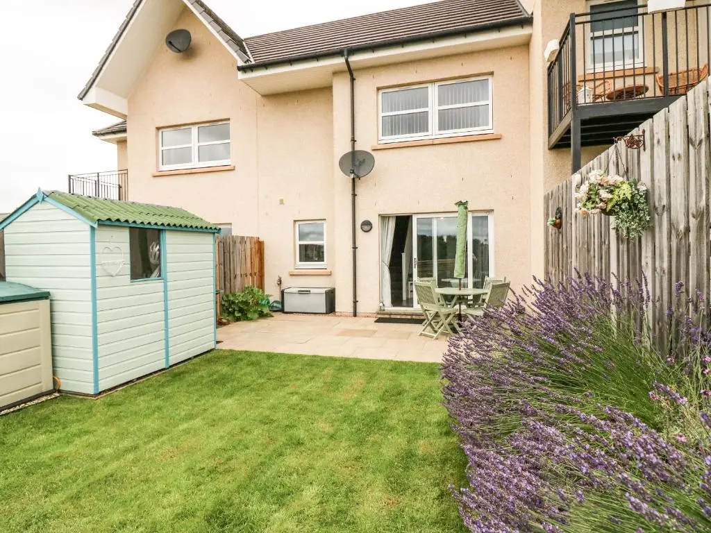 a house with a garden and a fence at 38 The Views in Elgin