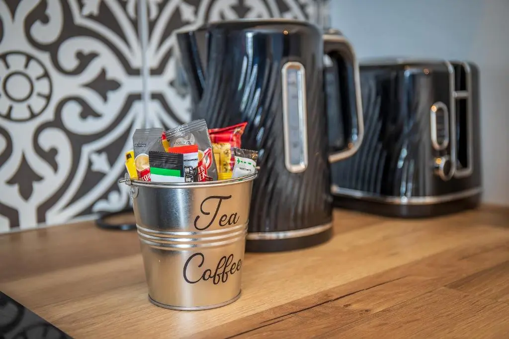 two coffee pots sitting on top of a counter at Great Glen Way Canal Side Apartment in Inverness