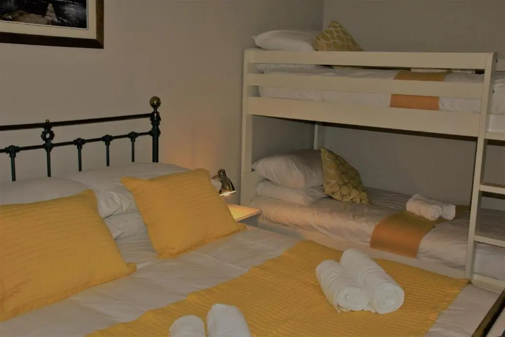a bedroom with two bunk beds with towels at Bellevue Holiday Cottage in Gardenstown