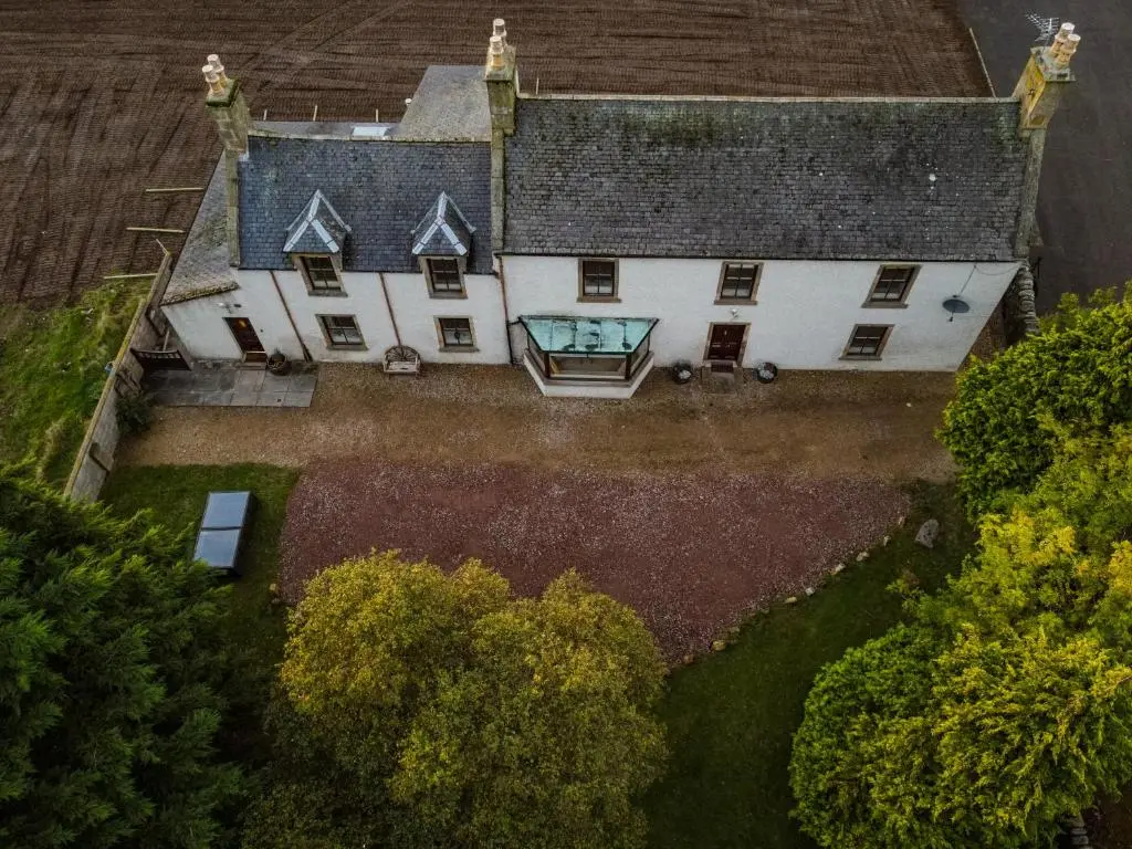 an aerial view of a large house with a window at The Farmhouse, 6 bed property, Forres in Forres