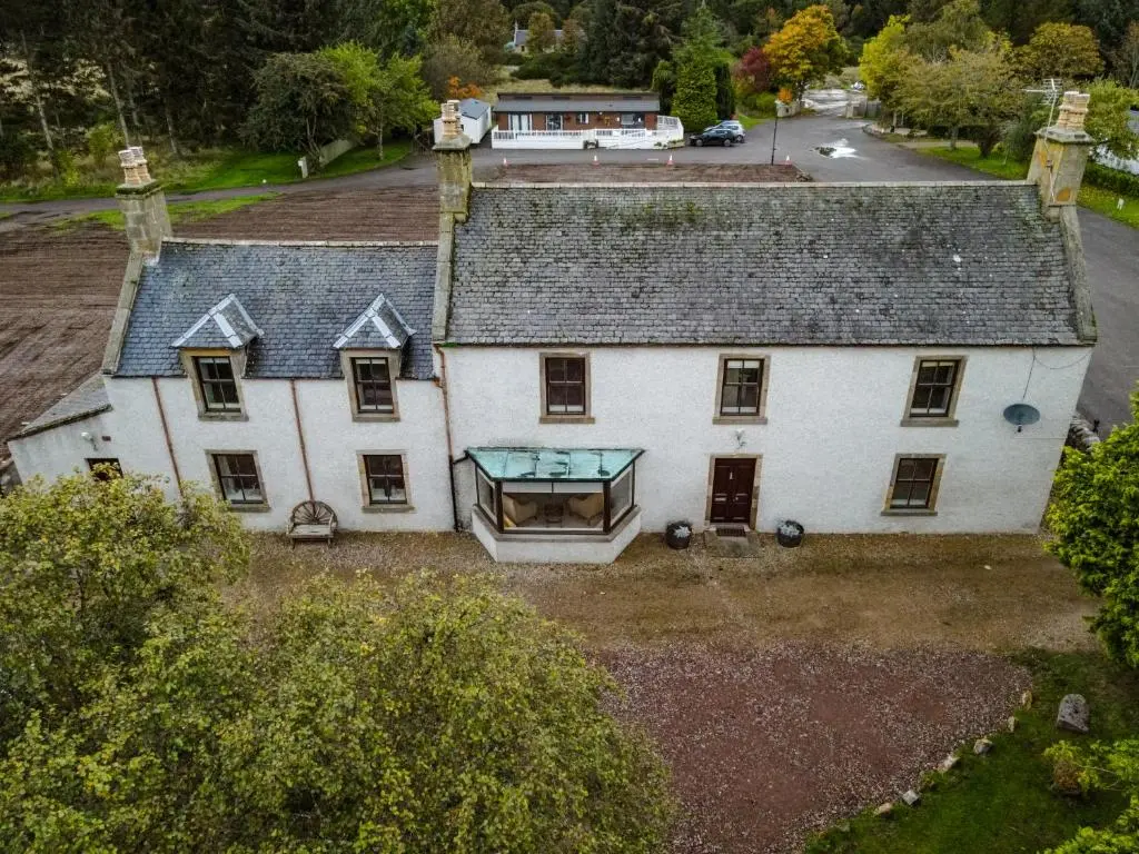 an aerial view of a large white house at The Farmhouse, 6 bed property, Forres in Forres