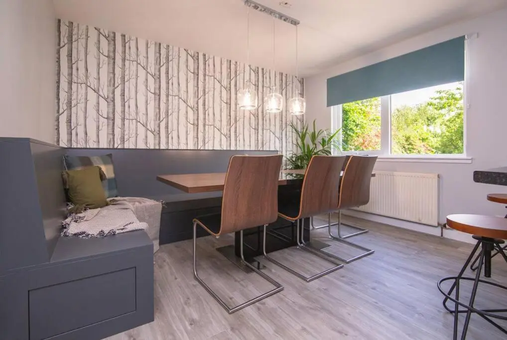 a dining room with a table and chairs at Calm Scottish Country Escape with Hot Tub Sleeps 6 in Inverness