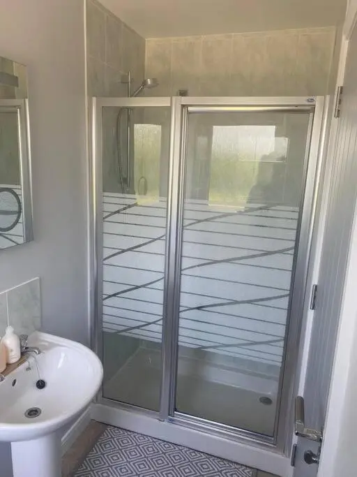 a bathroom with a shower and a toilet and a sink at Calm Scottish Country Escape with Hot Tub Sleeps 6 in Inverness