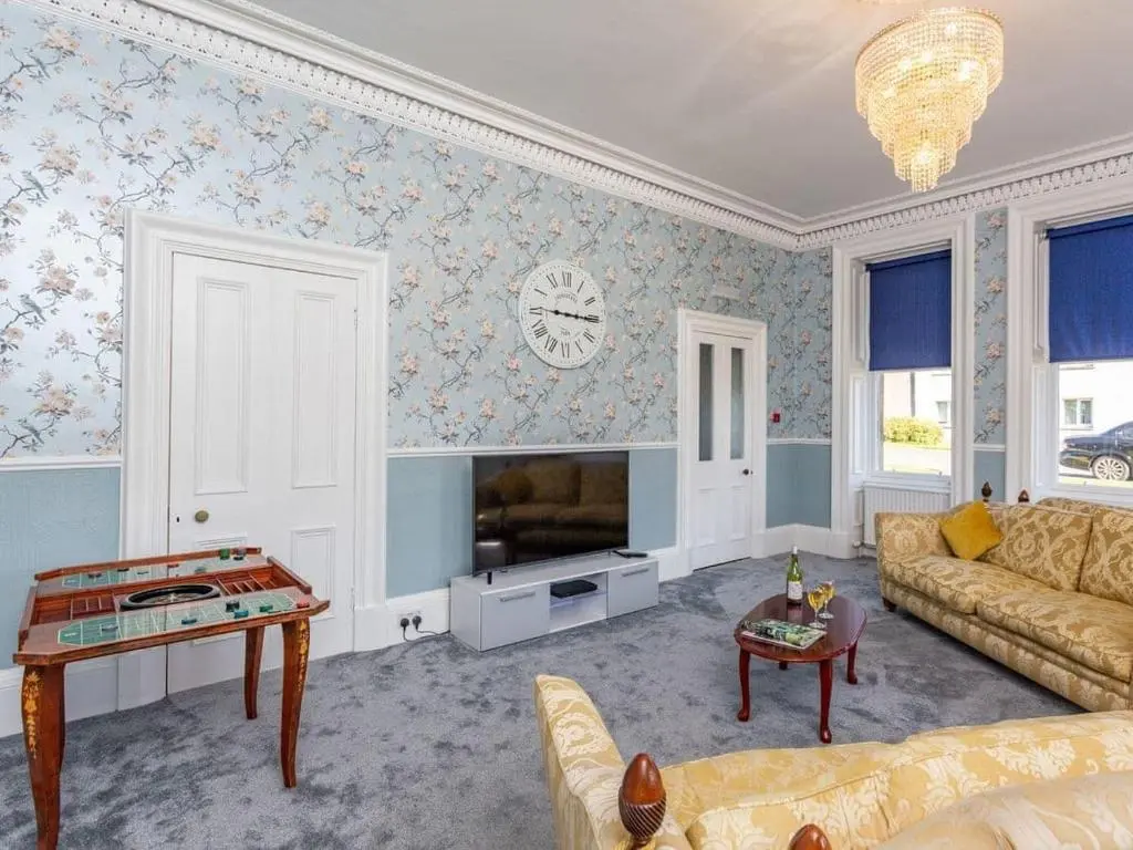 a living room with a couch and a table at North Bank House in Lybster