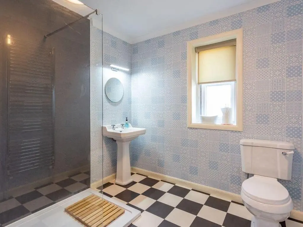 a bathroom with a toilet and a sink and a shower at North Bank House in Lybster
